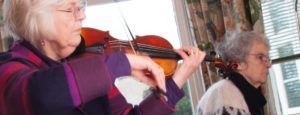 elderly woman playing violin