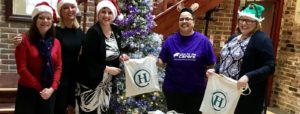 photo of heringtons solicitors with young carers standing by a christmas tree