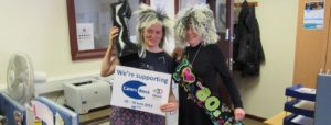 2 carers dancing at an 80's party in fancy dress