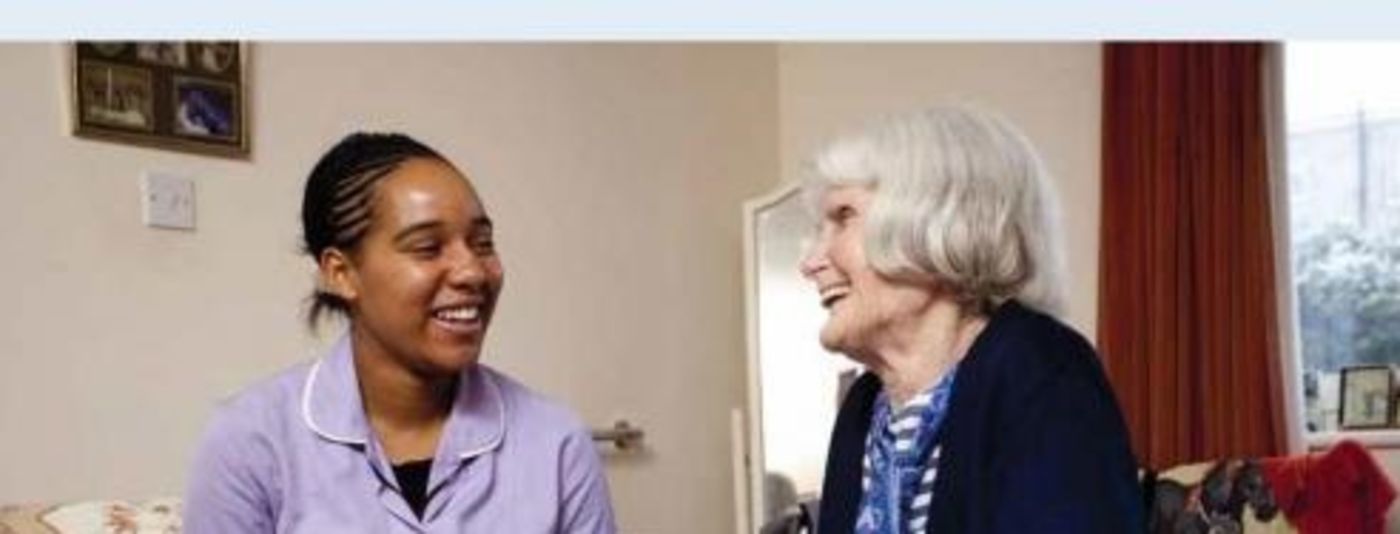 photo of caraer chatting with elderly woman