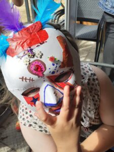 A young carer wearing a mask they designed and made.