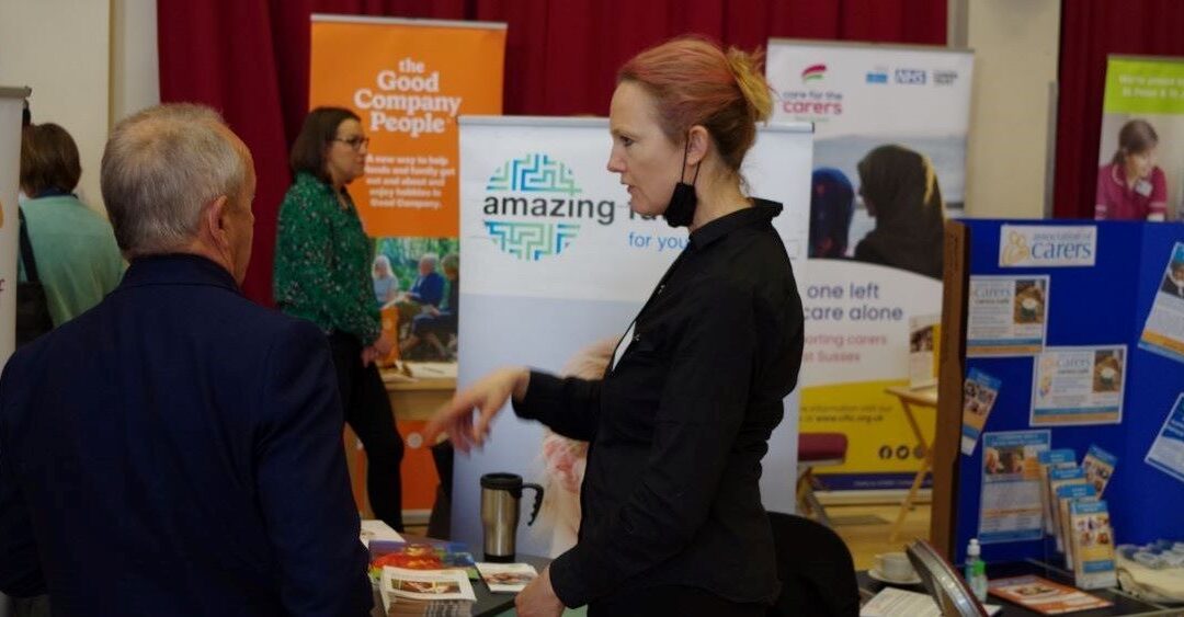 Two people talking at a conference in front of banners