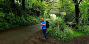Image of male walker in blue top on a woodland track