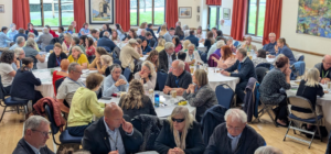 delegates sitting around tables in a hall